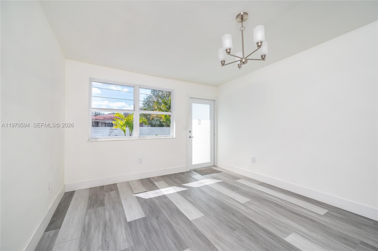 2433 Northwest 97th Street Miami, FL 33147 - Photo 26 of 41 wooden floor in an empty room with a window