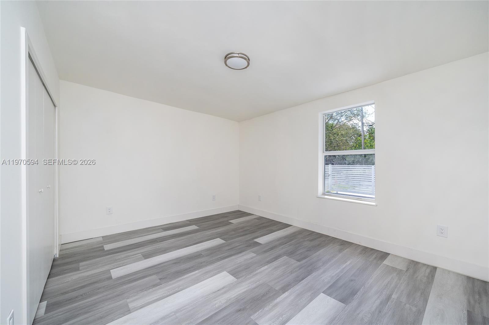 2433 Northwest 97th Street Miami, FL 33147 - Photo 38 of 41 a view of room with window and hardwood floor