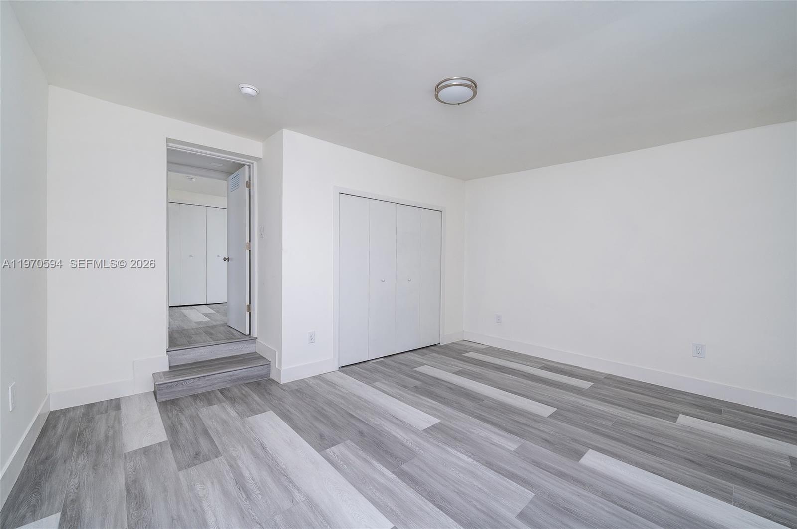 2433 Northwest 97th Street Miami, FL 33147 - Photo 39 of 41 a view of a room with wooden floor and white doors