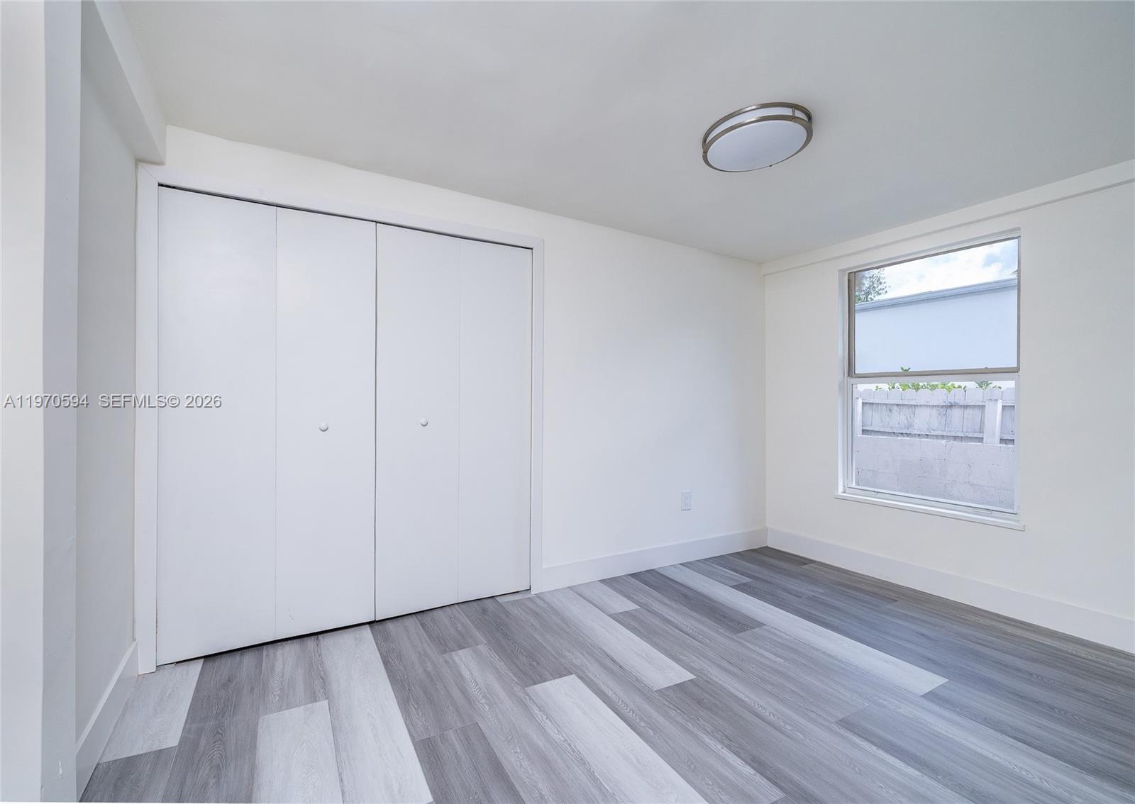2433 Northwest 97th Street Miami, FL 33147 - Photo 40 of 41 a view of an empty room with wooden floor and a window