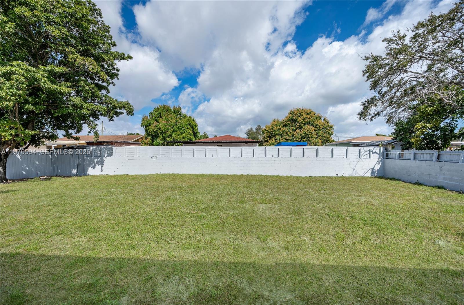 2433 Northwest 97th Street Miami, FL 33147 - Photo 8 of 41 a view of outdoor space with green field