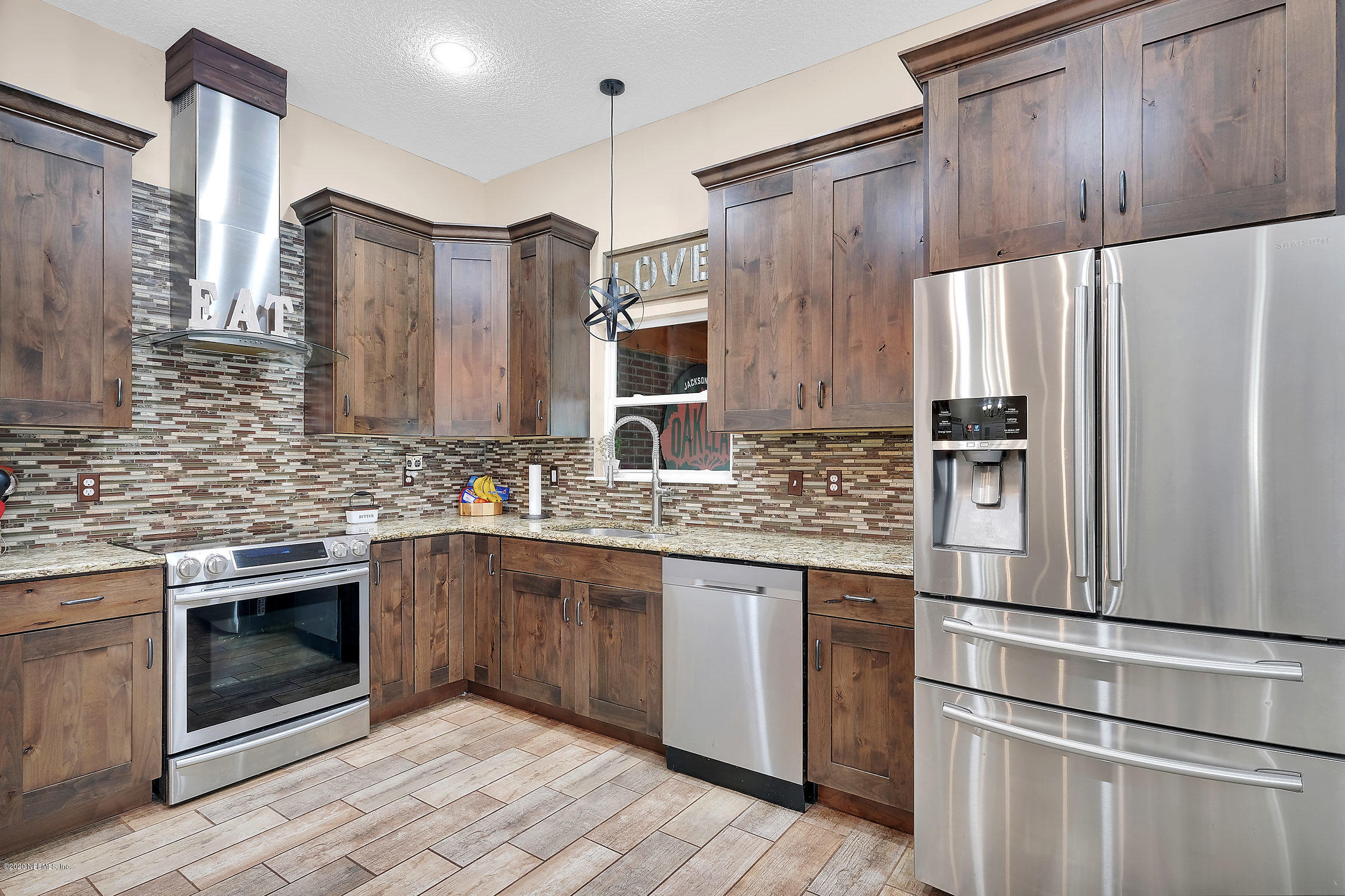 651 Timbermill Lane Orange Park, FL 32065 - Photo 15 of 34 a kitchen with stainless steel appliances granite countertop a refrigerator a stove and a sink