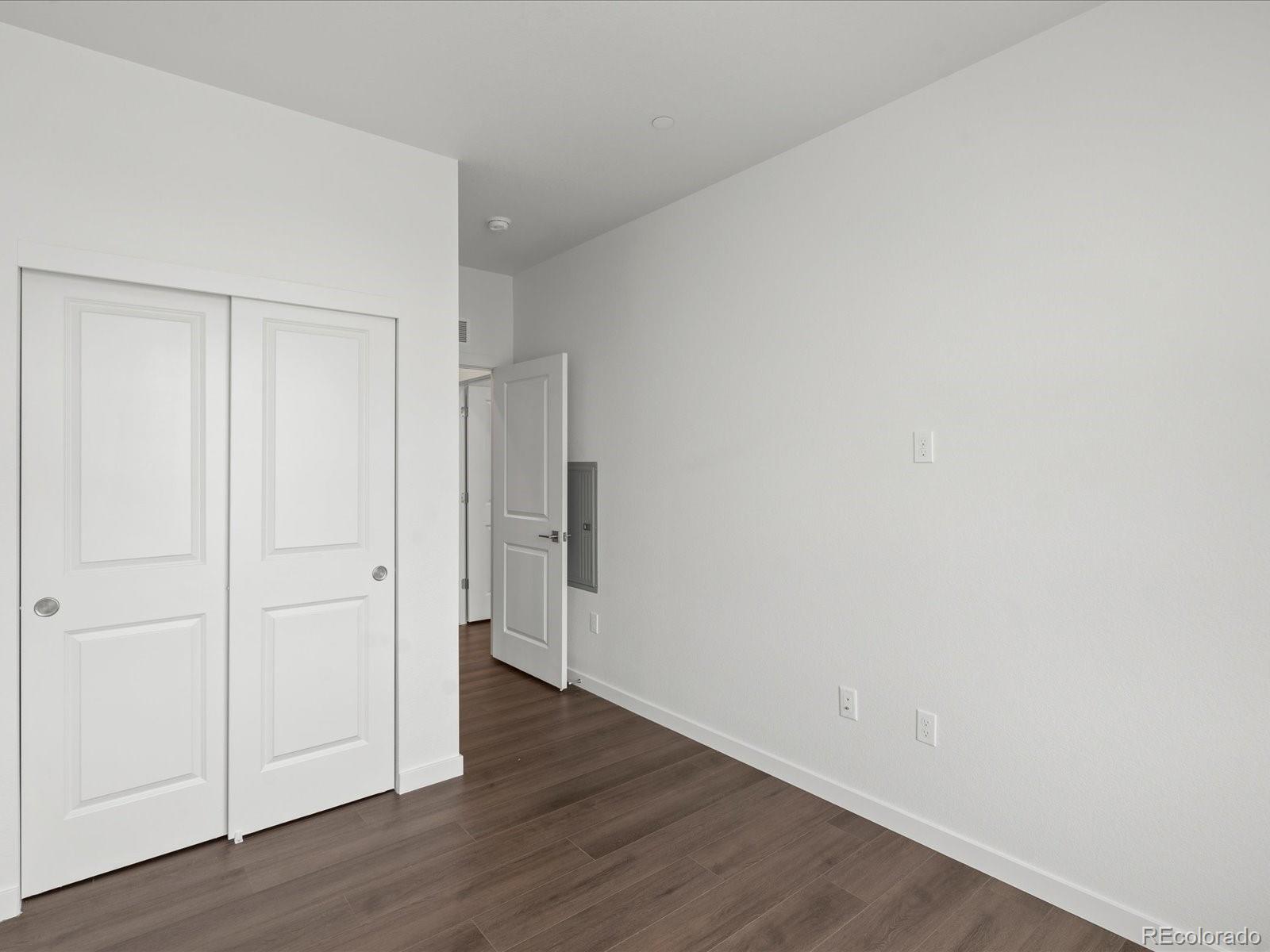 6153 North Ceylon Street, Unit 304 Denver, CO 80249 - Photo 18 of 24 a view of an empty room with wooden floor