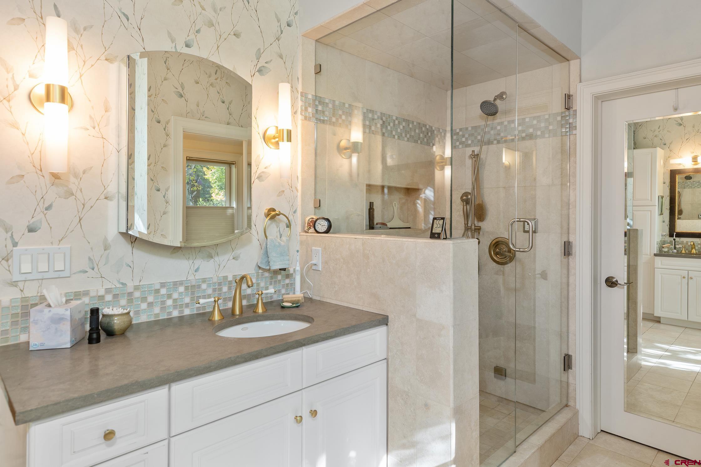 721 East Columbia Avenue Telluride, CO 81435 - Photo 17 of 44 a bathroom with a shower sink and mirror