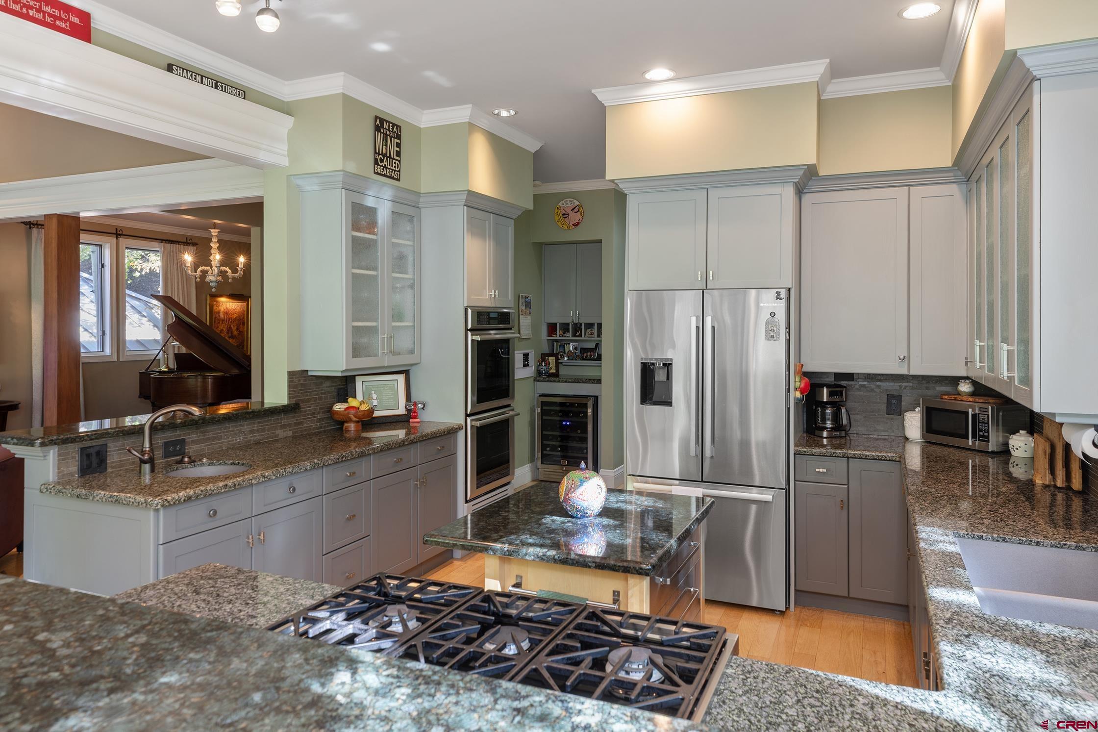 721 East Columbia Avenue Telluride, CO 81435 - Photo 6 of 44 a kitchen with stainless steel appliances granite countertop a sink stove and refrigerator