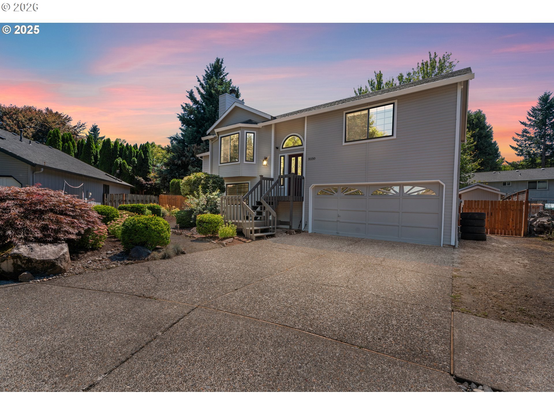 31150 Southwest Wallowa Court Wilsonville, OR 97070 - Photo 31 of 43 a view of a house with a backyard and a garage