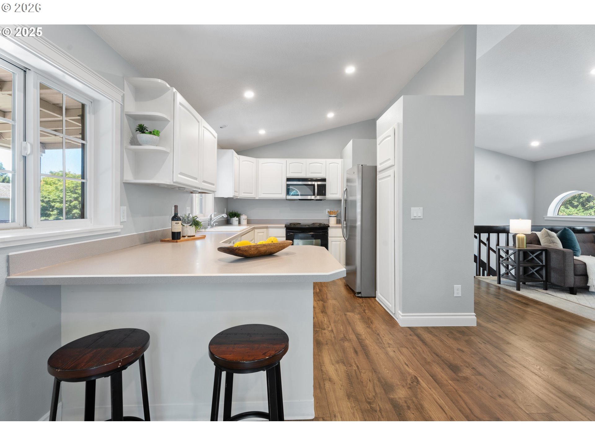 31150 Southwest Wallowa Court Wilsonville, OR 97070 - Photo 41 of 43 a kitchen with stainless steel appliances a dining table chairs refrigerator and sink