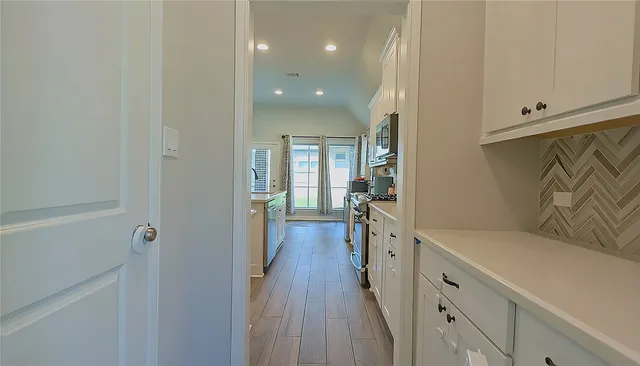 a view of a house with a yard and pathway