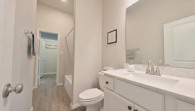 a view of a hallway with wooden floor and closet