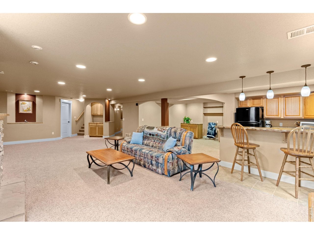 6710 31st St Road Greeley, CO 80634 - Photo 41 of 41 Open floorplan in the basement with fireplace and wet bar.