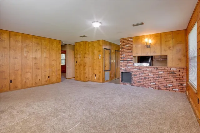 a view of an empty room with a fireplace