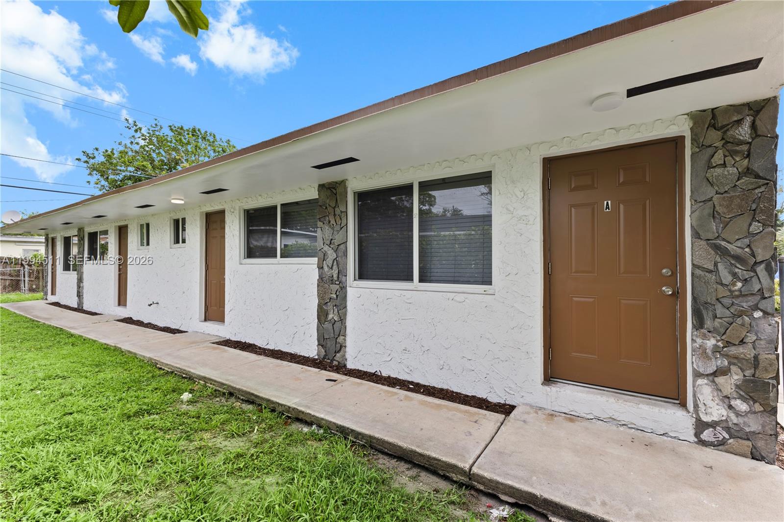6121 Southwest 40th Court, Unit A Miramar, FL 33023 - Photo 2 of 12 a front view of a house with a yard