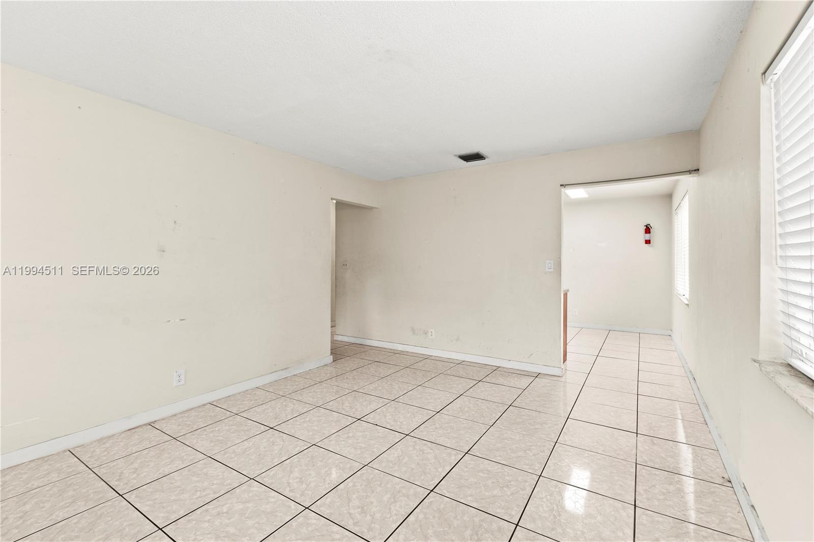 6121 Southwest 40th Court, Unit A Miramar, FL 33023 - Photo 3 of 12 a view of an empty room and window
