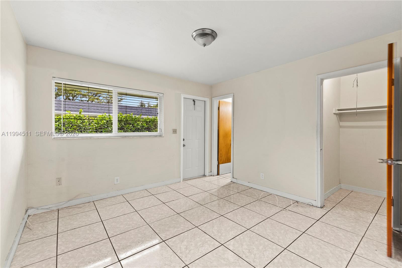 6121 Southwest 40th Court, Unit A Miramar, FL 33023 - Photo 7 of 12 a view of an empty room and window