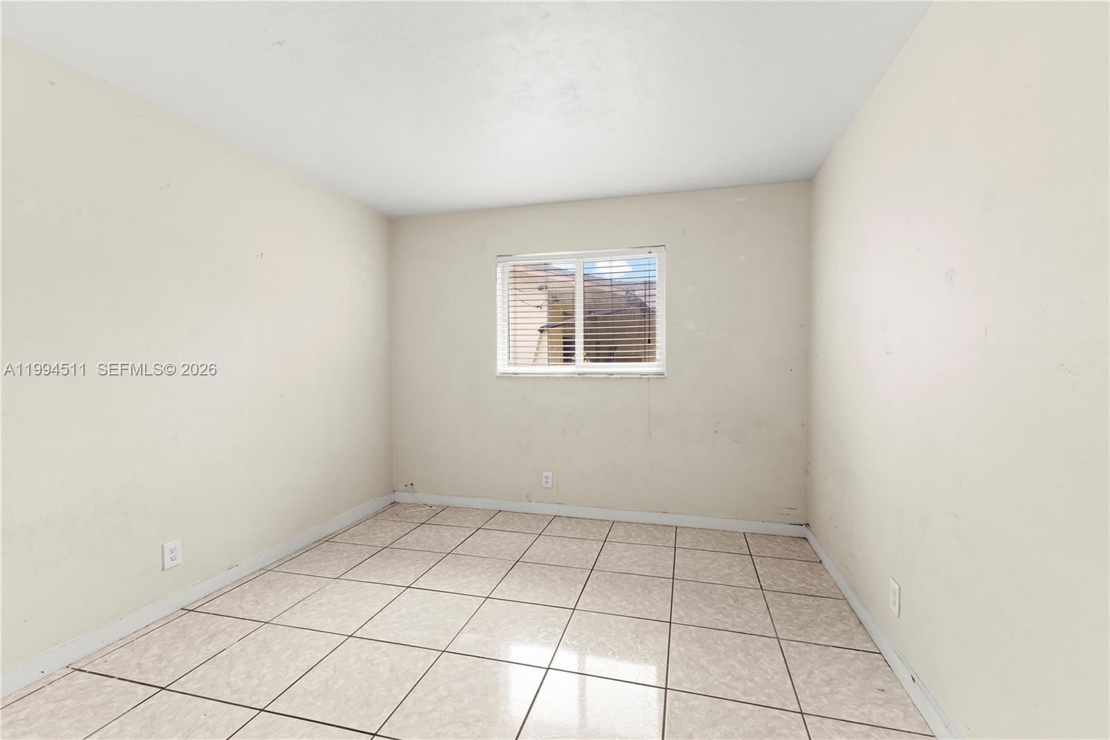 6121 Southwest 40th Court, Unit A Miramar, FL 33023 - Photo 10 of 12 a view of an empty room with a window