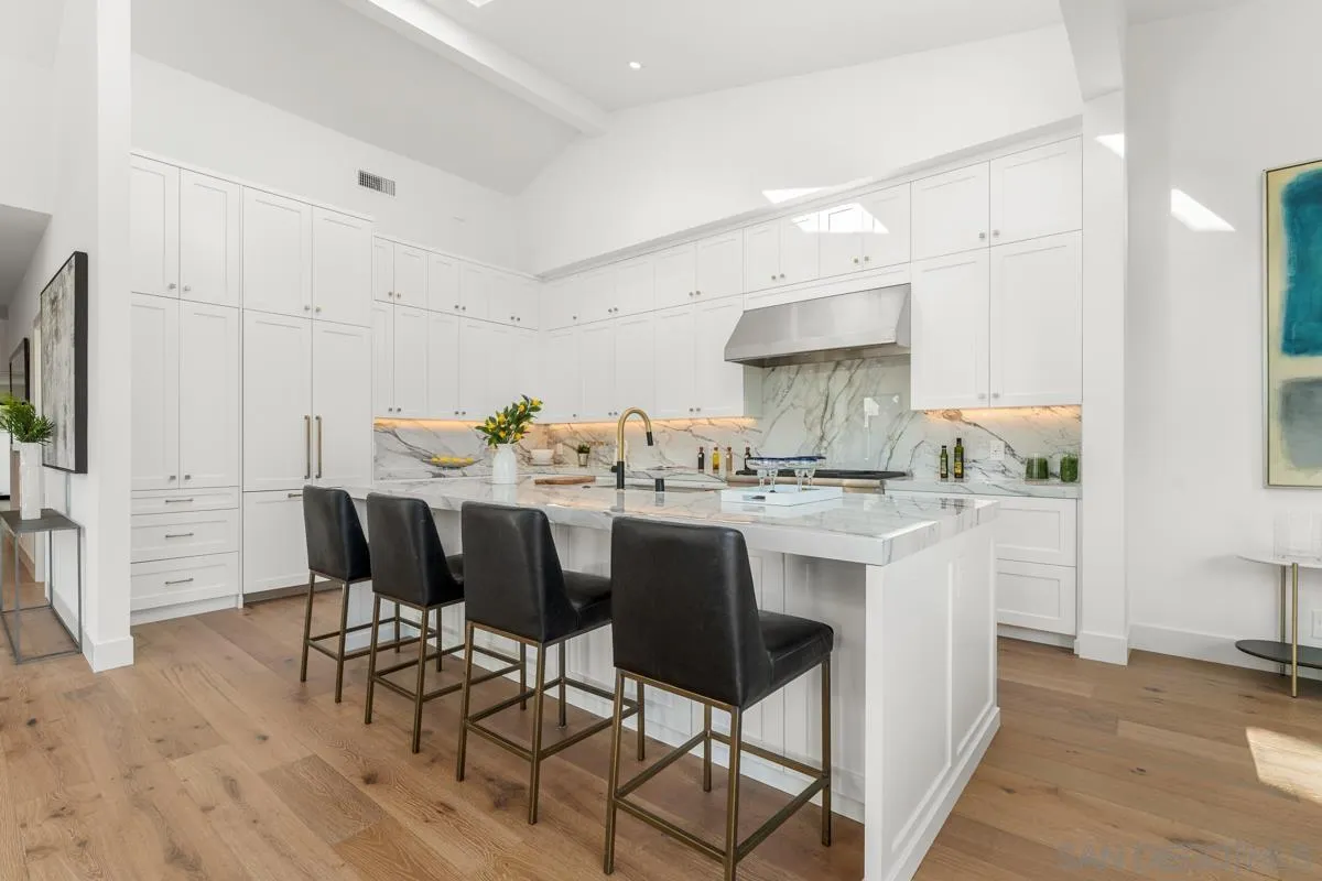 34 Jetty Drive Corona del Mar, CA 92625 - Photo 13 of 33 a kitchen with stainless steel appliances kitchen island granite countertop a dining table chairs and a refrigerator