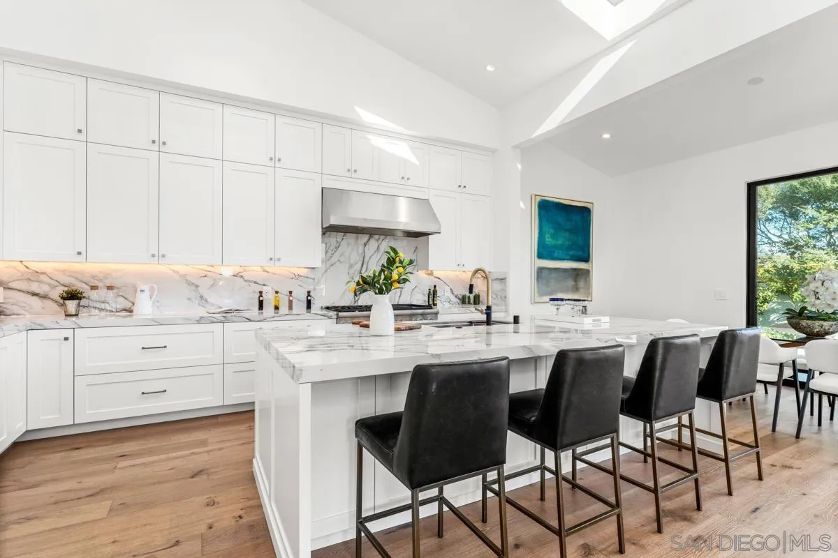 34 Jetty Drive Corona del Mar, CA 92625 - Photo 14 of 33 a kitchen with granite countertop white cabinets and chairs