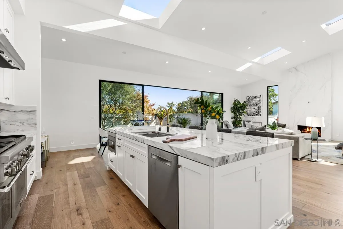 34 Jetty Drive Corona del Mar, CA 92625 - Photo 15 of 33 a kitchen with a sink stove and cabinets