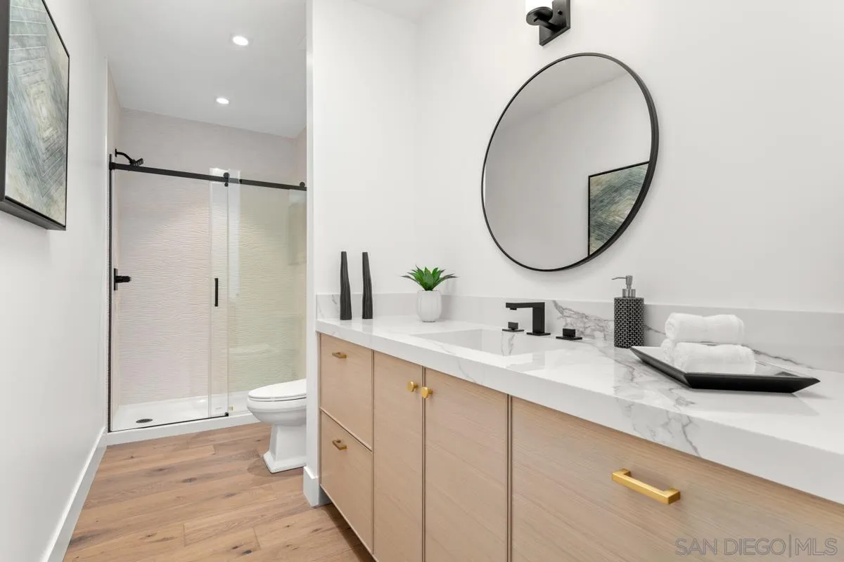 34 Jetty Drive Corona del Mar, CA 92625 - Photo 20 of 33 a bathroom with a toilet a sink and a mirror