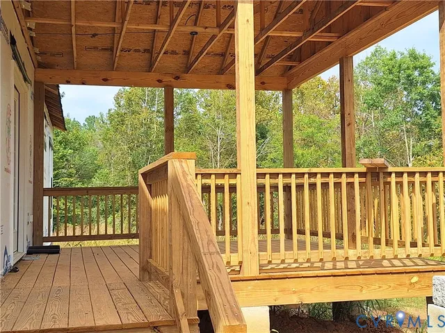 a view of a balcony with wooden floor and outdoor space