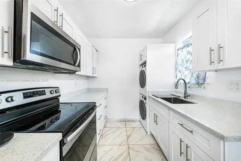 a kitchen with stainless steel appliances a sink stove and microwave