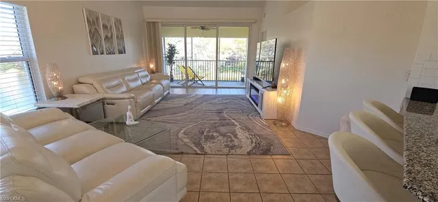 a kitchen with stainless steel appliances granite countertop a refrigerator a stove a sink and a microwave