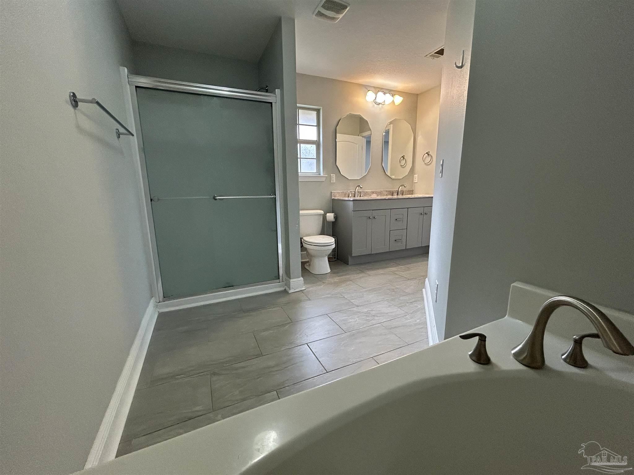 3405 Wasatch Range Loop Pensacola, FL 32526 - Photo 12 of 13 a bathroom with a sink a toilet and shower