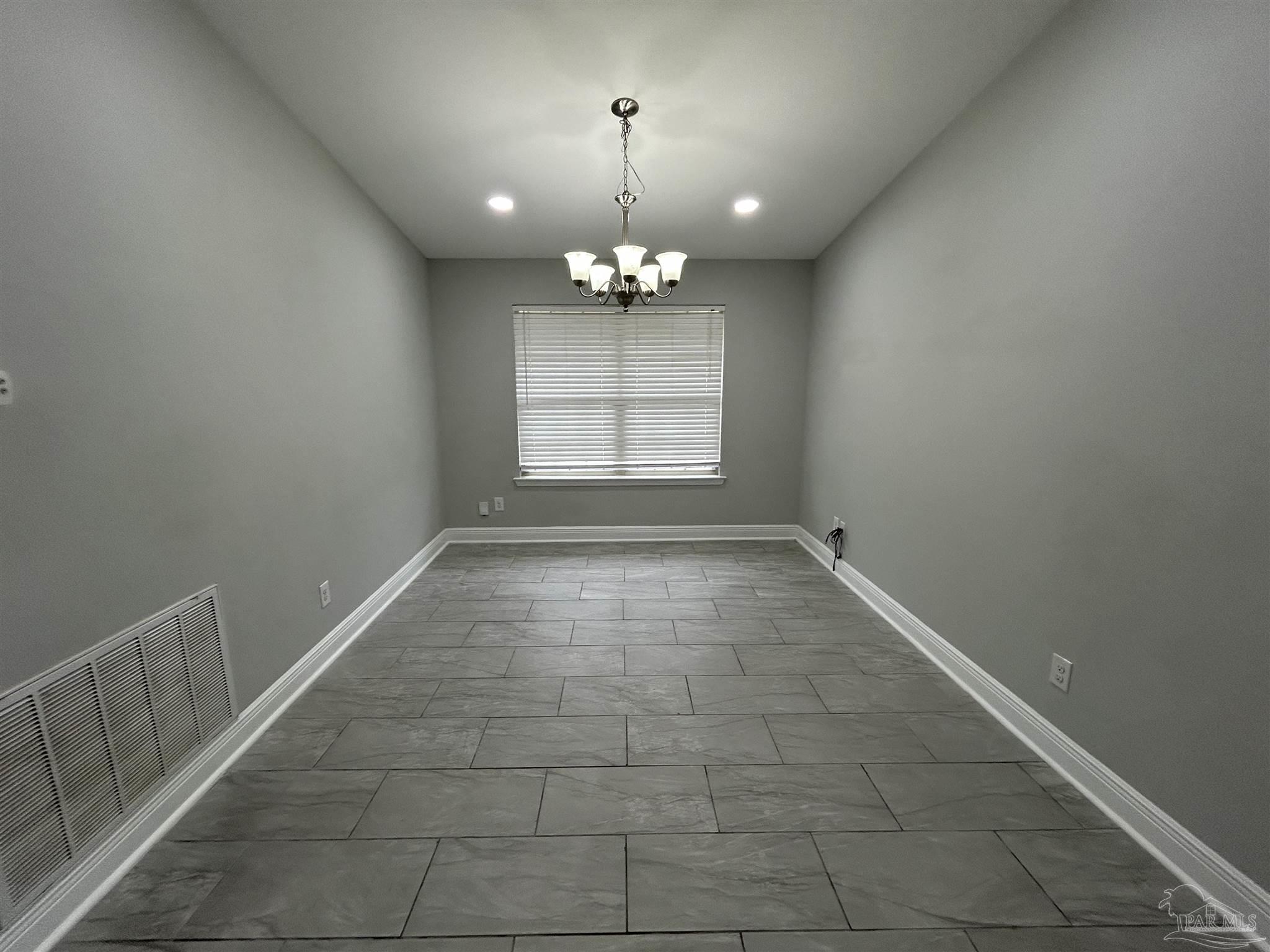 3405 Wasatch Range Loop Pensacola, FL 32526 - Photo 2 of 13 en empty room with windows and chandelier