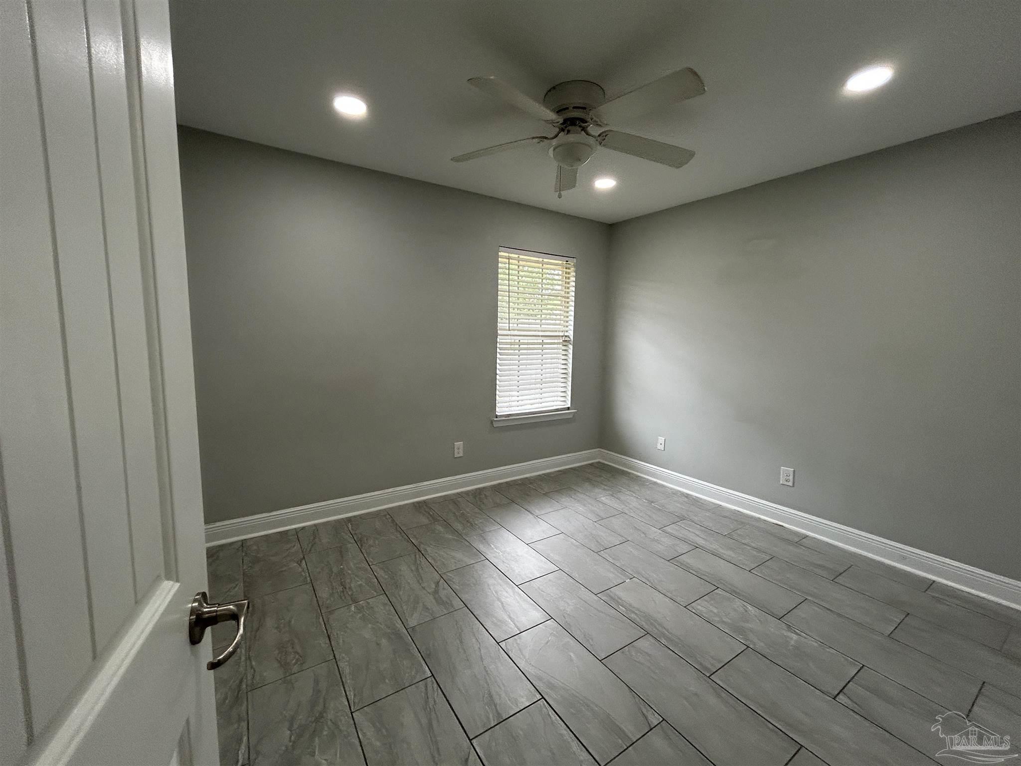 3405 Wasatch Range Loop Pensacola, FL 32526 - Photo 7 of 13 an empty room with windows and fan