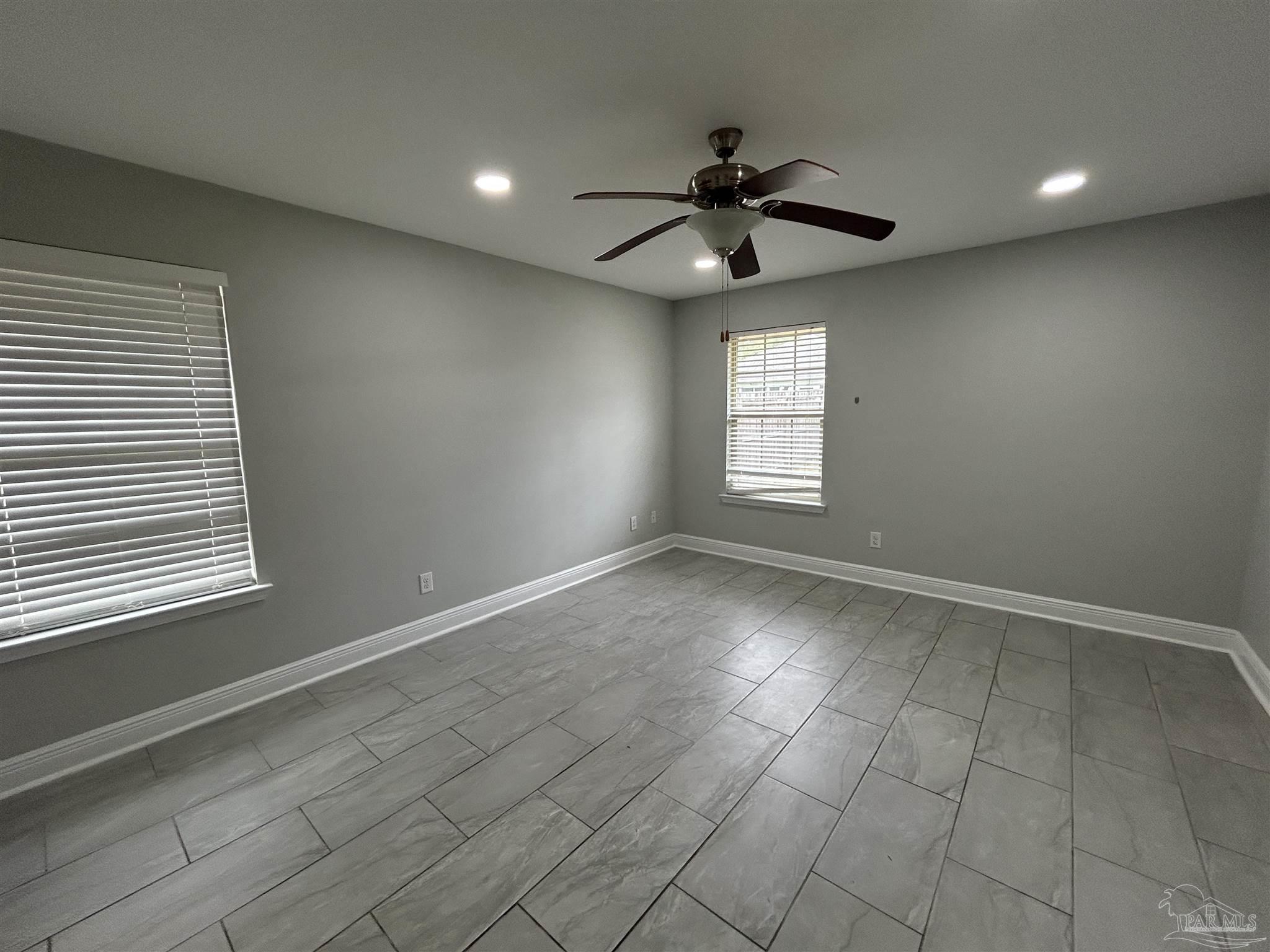 3405 Wasatch Range Loop Pensacola, FL 32526 - Photo 8 of 13 an empty room with windows and fan