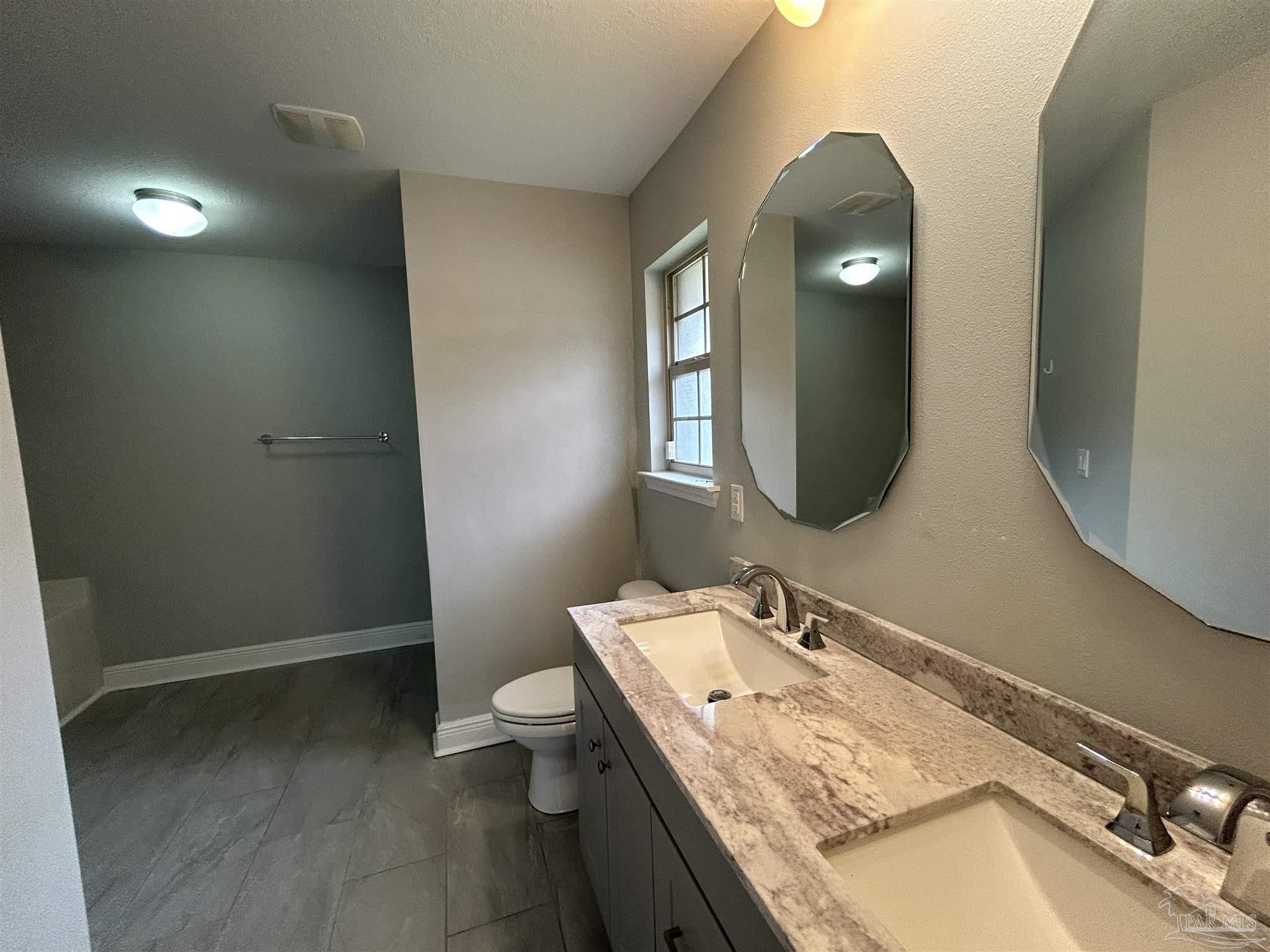 3405 Wasatch Range Loop Pensacola, FL 32526 - Photo 9 of 13 a bathroom with a granite countertop sink and a mirror