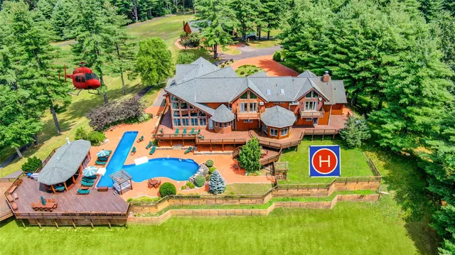 an aerial view of residential house with outdoor space and swimming pool