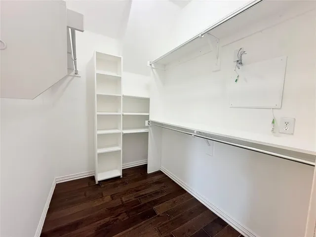 a view of walk in closet with empty racks