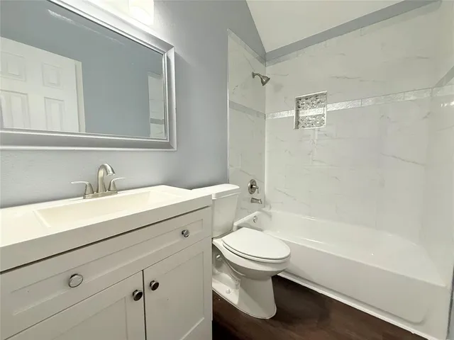 a bathroom with a sink toilet a mirror and shower