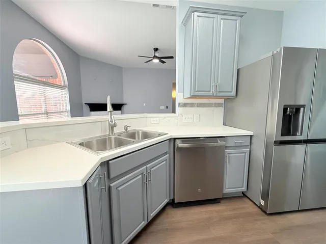 a kitchen with a sink cabinets and a refrigerator
