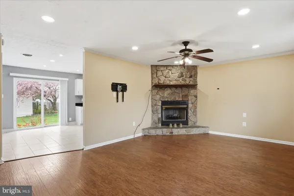 an empty room with windows and fireplace