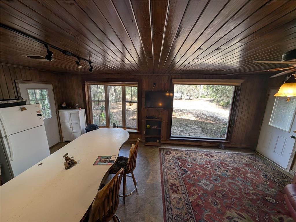 13668 Northeast 226th Avenue Road Salt Springs, FL 32134 - Photo 16 of 30 a view of a dining room with furniture window and wooden floor