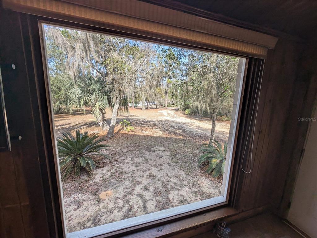 13668 Northeast 226th Avenue Road Salt Springs, FL 32134 - Photo 19 of 30 a view of a room with wooden floor and a porch