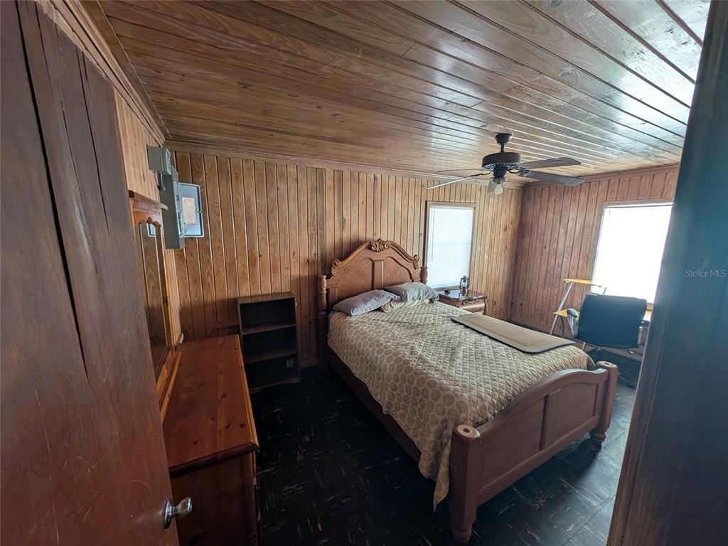 13668 Northeast 226th Avenue Road Salt Springs, FL 32134 - Photo 27 of 30 a bed sitting in a bedroom next to a window