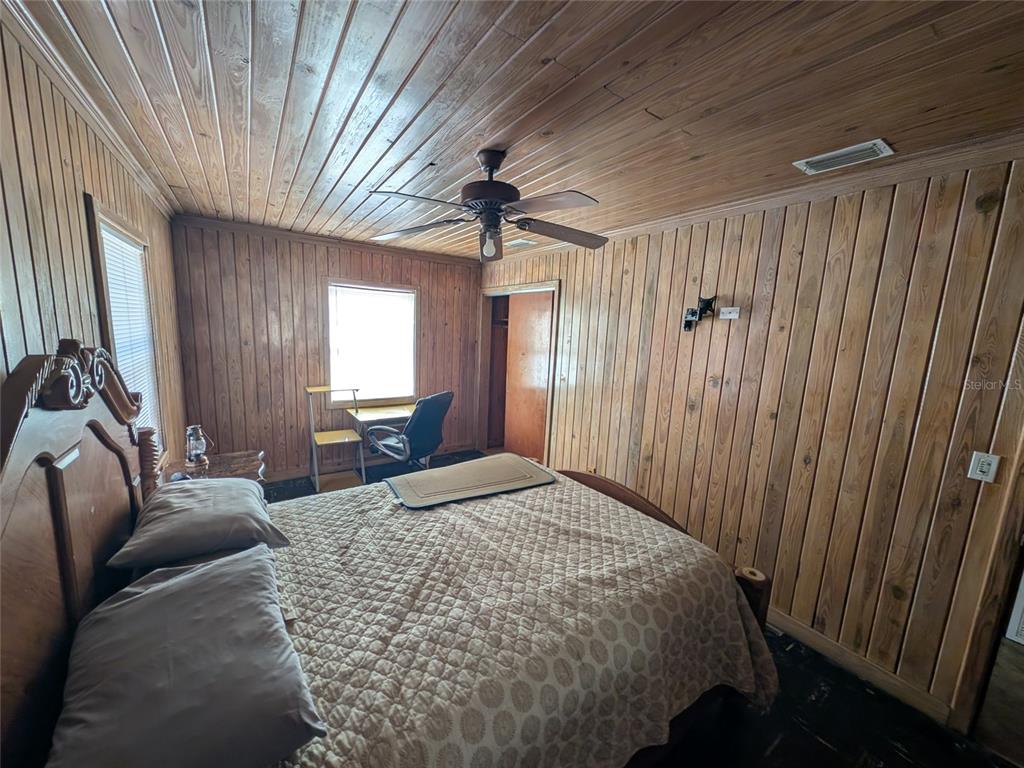 13668 Northeast 226th Avenue Road Salt Springs, FL 32134 - Photo 28 of 30 a bed sitting in a spacious bedroom next to a window