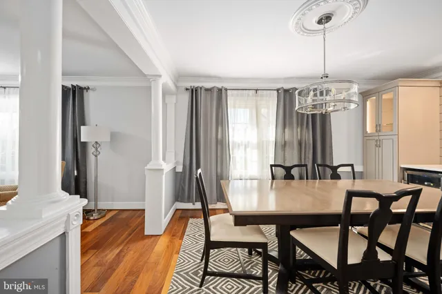 a large kitchen with stainless steel appliances a large counter top a stove a sink and a refrigerator