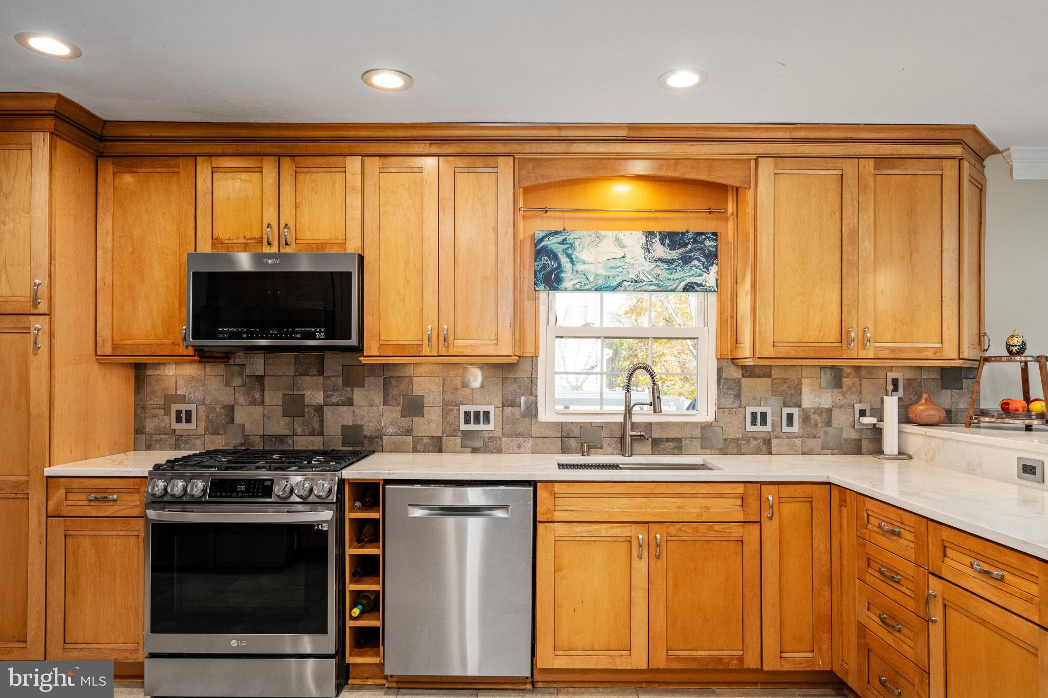 224 Prince Street Northeast Leesburg, VA 20176 - Photo 20 of 84 a kitchen with stainless steel appliances a sink stove and cabinets