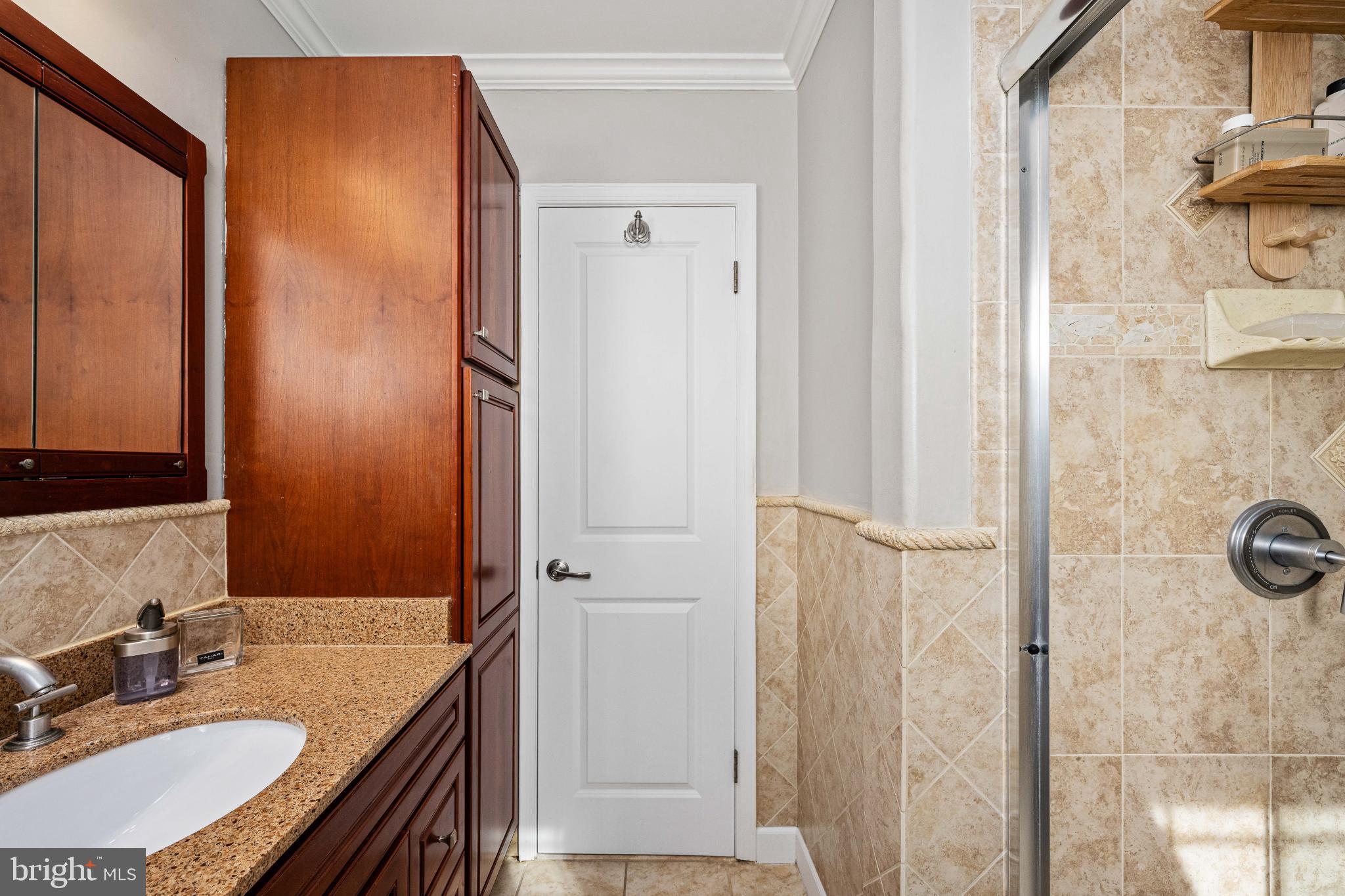 224 Prince Street Northeast Leesburg, VA 20176 - Photo 30 of 84 a bathroom with a granite countertop shower sink and mirror