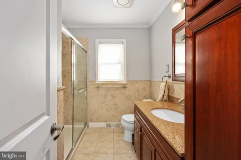 a view of a living room with a fireplace and a glass door