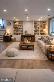 a large living room with stainless steel appliances granite countertop furniture and a fireplace