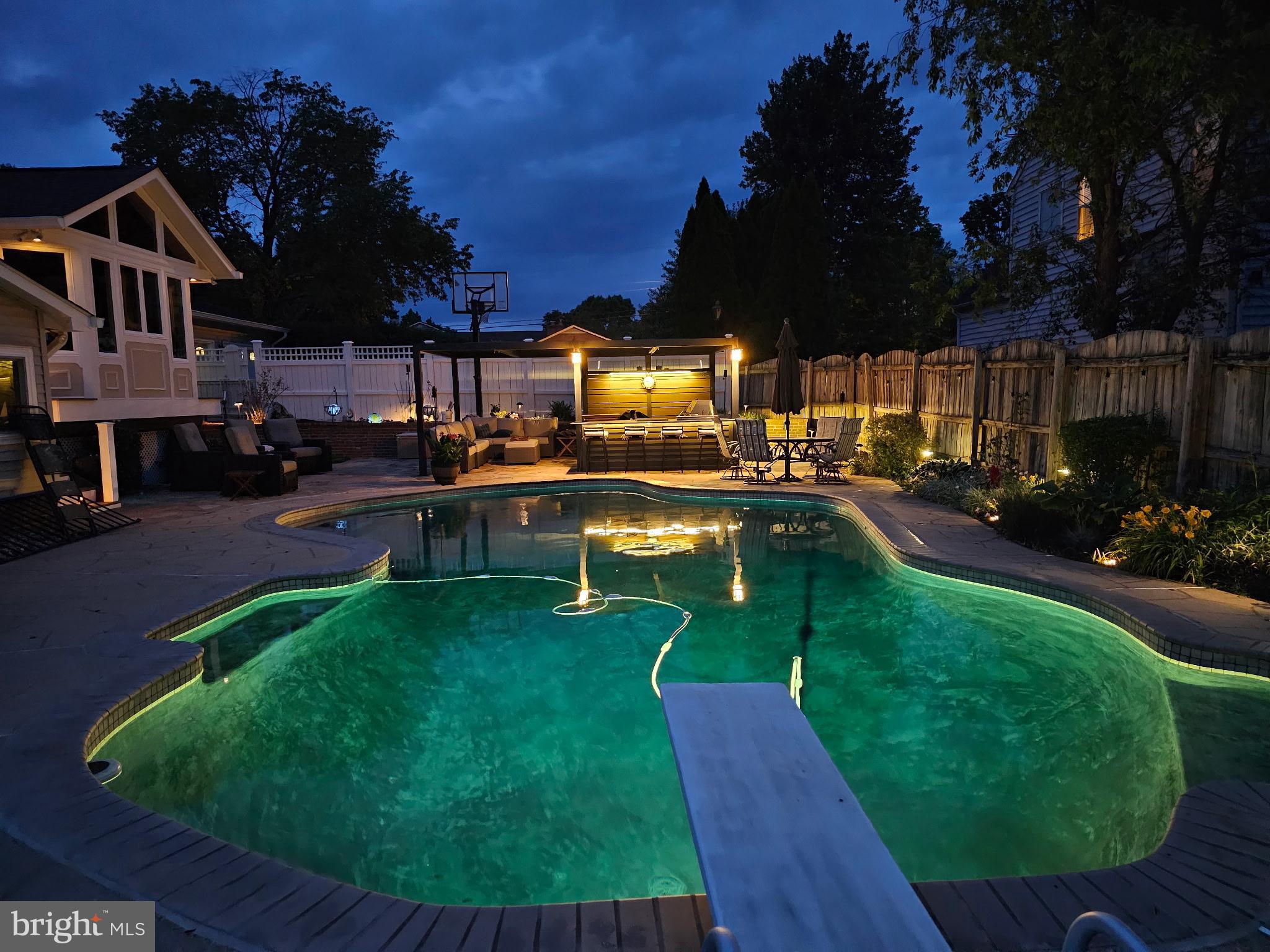 224 Prince Street Northeast Leesburg, VA 20176 - Photo 82 of 84 Serene evening by the illuminated pool.