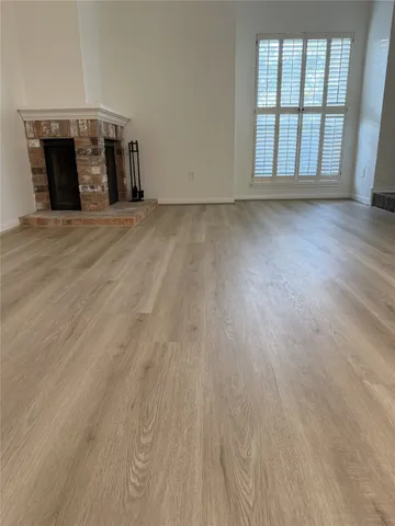 a view of a hallway with wooden floor and a livingroom view