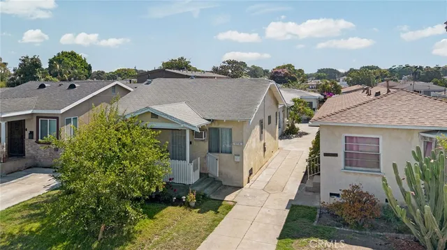 a aerial view of a house with a yard and potted plants