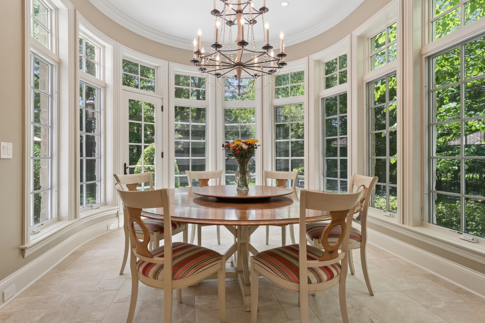 1128 Mt Pleasant Road Winnetka, IL 60093 - Photo 20 of 58 a view of a dining room with furniture large windows and wooden floor