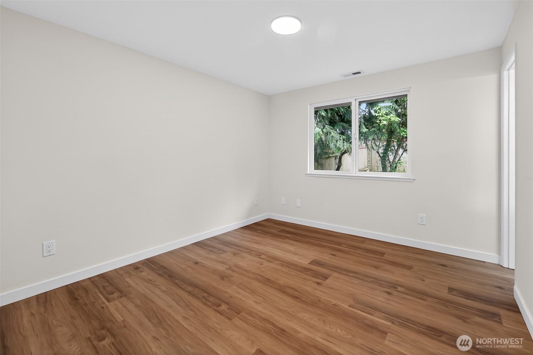 320 213th Place Southwest Bothell, WA 98021 - Photo 18 of 29 an empty room with wooden floor and windows